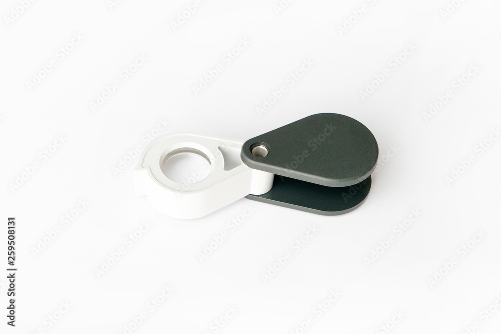 Magnifying glass for diamonds or see the amulet Isolated on a White Background. Magnifying glass for diamonds or see the amulet Isolated on a White Background.