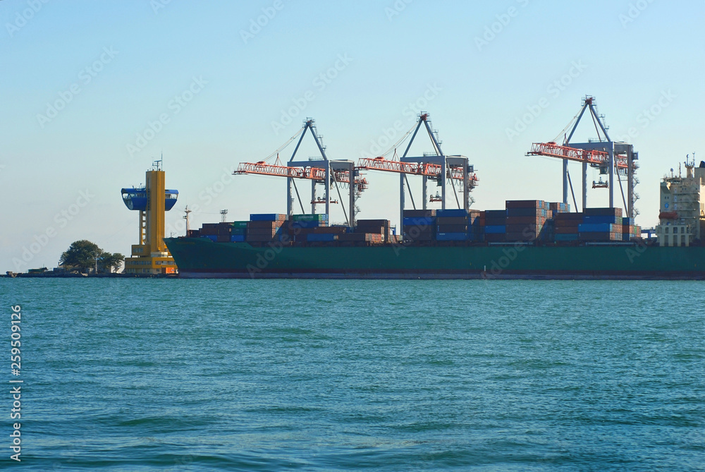 Odessa seaport, Odessa, Ukraine. Cranes and ships in the port against a background of blue sky.