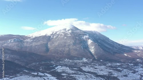 Clouds over the top of snowed Rtanj mountain 4K drone video photo