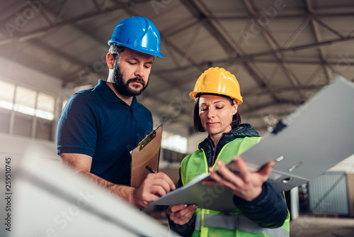 Factory worker signing document