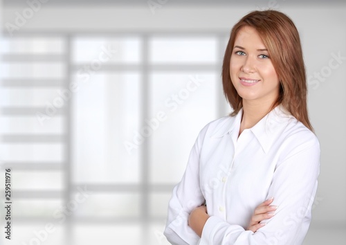 Free Download Young businesswoman in suit on blurred office interior background - GFXLoad