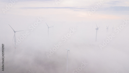 Wallpaper Mural Windmills in the fog at sunrise. Wind turbine from aerial view. Sustainable development, environment friendly. Torontodigital.ca