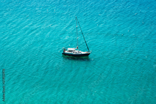 Yacht sailing in open transparent blue sea © Юлия Блажук