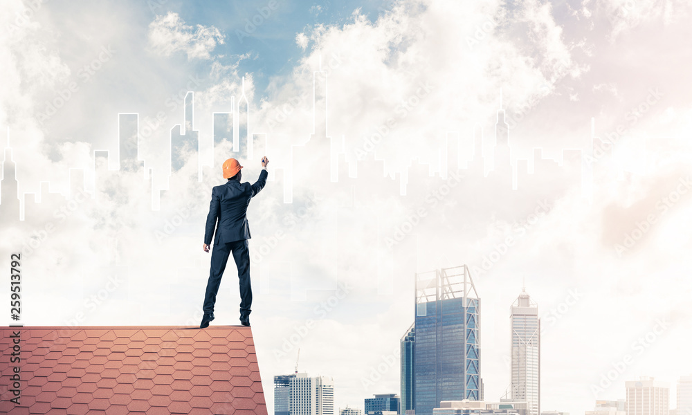 Man architect draw silhouette of modern city on blue sky. Mixed Man architect draw silhouette of modern city on blue sky. Mixed