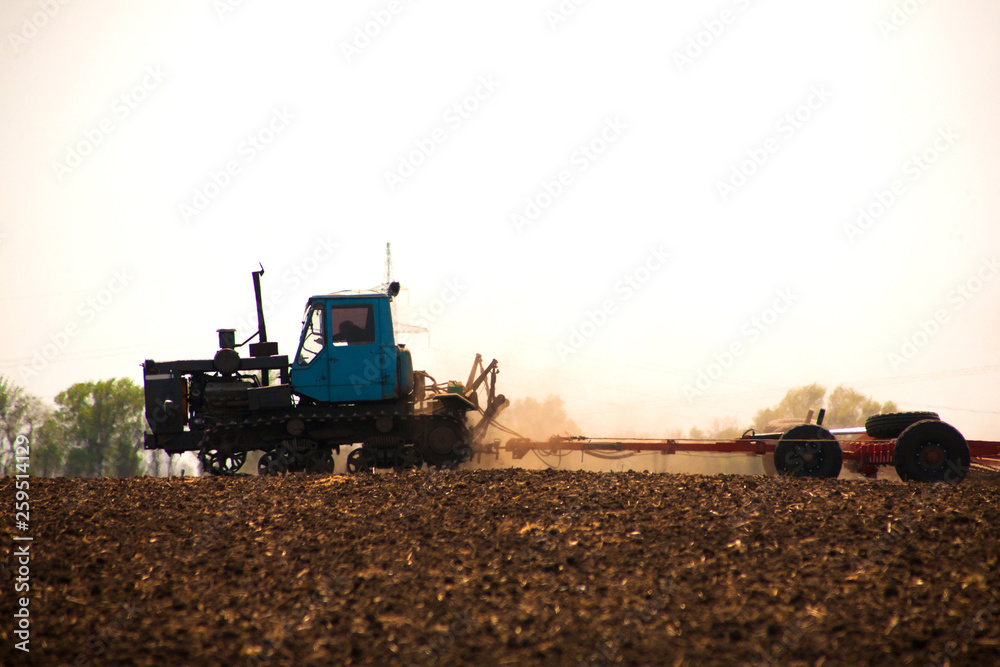 Fototapeta premium Tractor preparing land for sowing