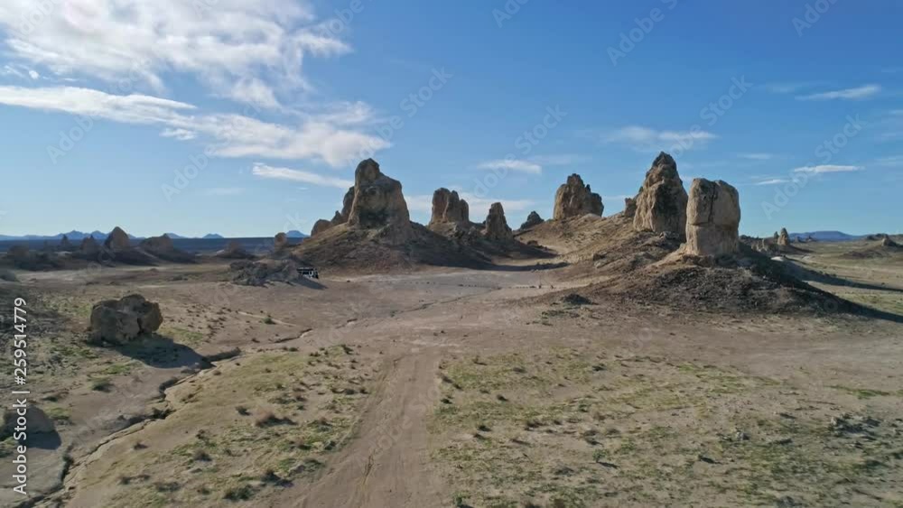 Low aerial view moving quickly toward the Trona Pinnacles rock formations on a sunny morning Low aerial view moving quickly toward the Trona Pinnacles rock formations on a sunny morning