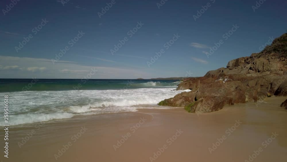 Waves rolling onto the beach in slow motion Waves rolling onto the beach in slow motion