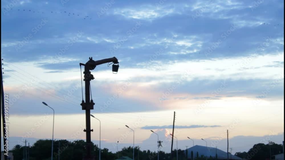 beautiful sunset view on a railway station with birds flying at the dark blue background. beautiful sunset view on a railway station with birds flying at the dark blue background.