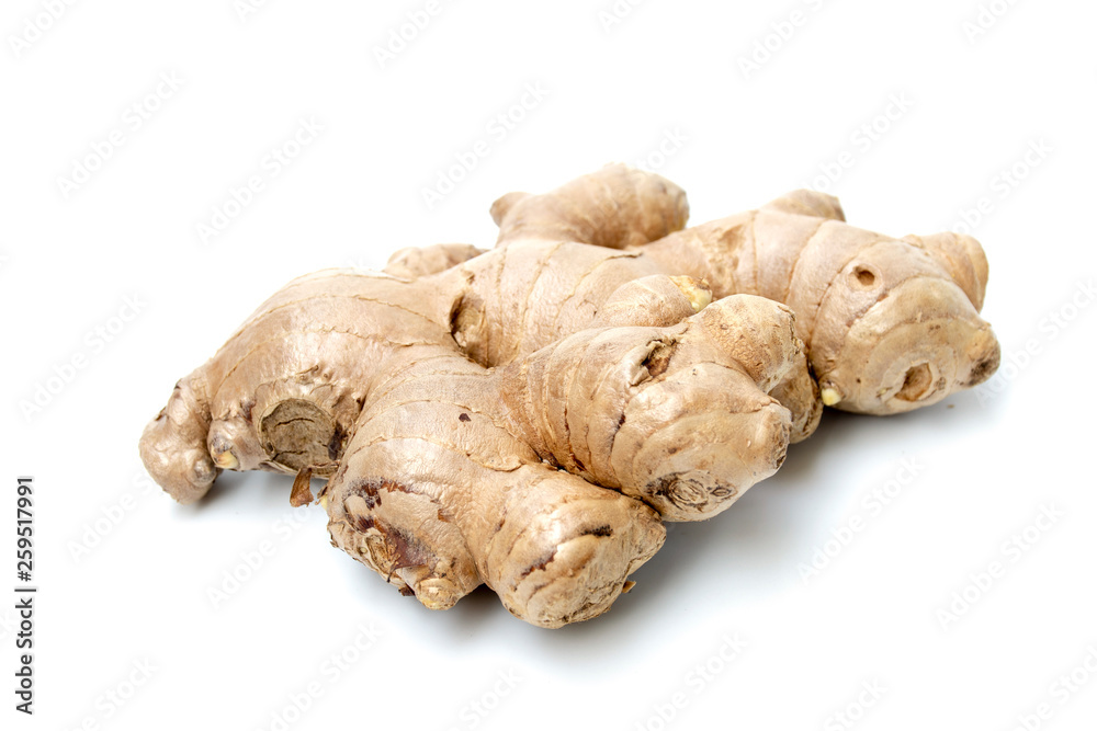 fresh ginger root closeup view, Thick tuberous vegetable with brown skin and pale yellow flesh on white background