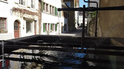 Handheld shot of old water fountain in a quiet town in Switzerland (Aarau, state of Aargau) photo