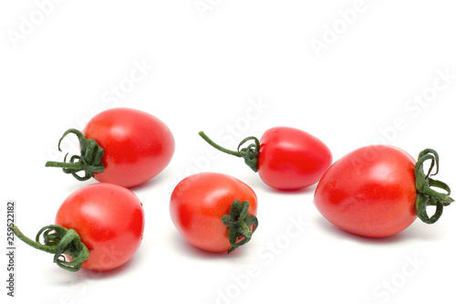 Close-up view the small fresh tomatoes isolated on a white background with a natural shadow. 