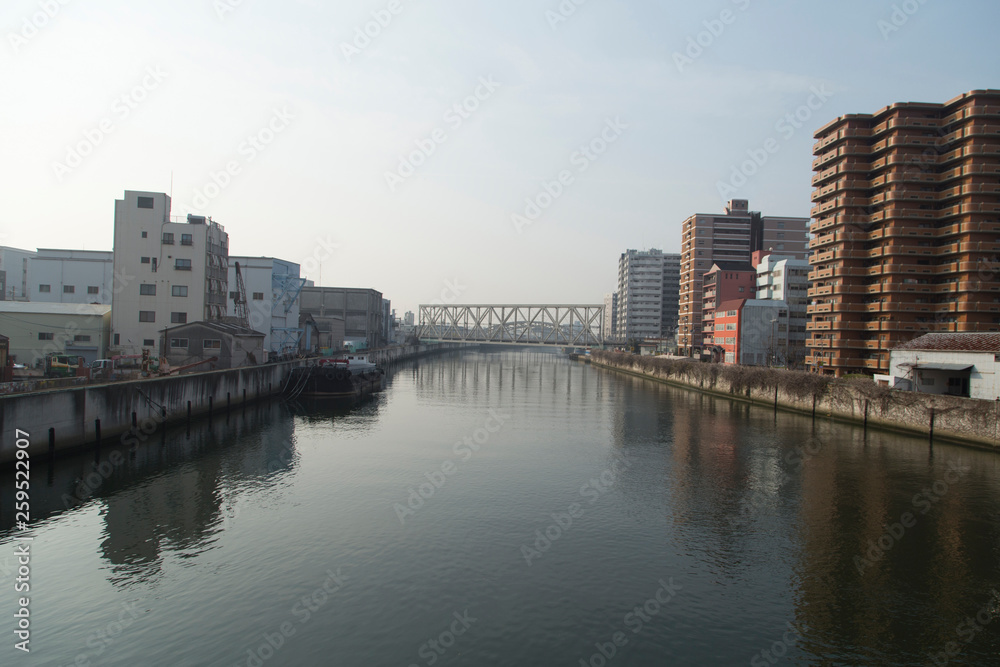 Cityscape with river, bridges and buildings in Osaka in spring clear day