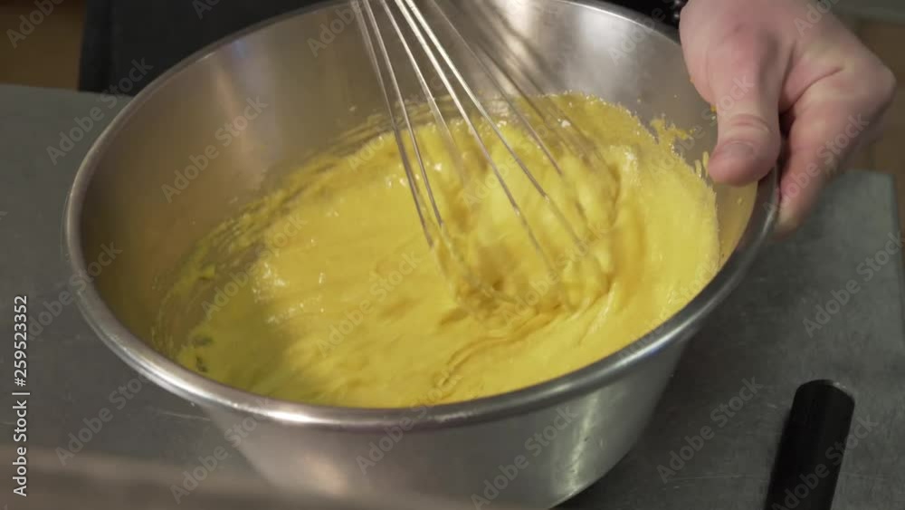 Chef Whisking Lemon Curd Mixture in a Mixing Bowl. Chef Whisking Lemon Curd Mixture in a Mixing Bowl.