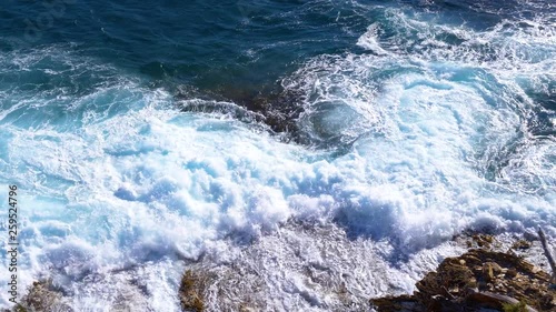 Waves and turmoils on coastal rocks and reefs. Mediterranean sea photo