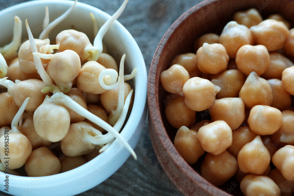 Whole and sprouted chickpea grains lie in plates. For a healthy lifestyle grains are germinated. Selective focus Whole and sprouted chickpea grains lie in plates. For a healthy lifestyle grains are germinated. Selective focus
