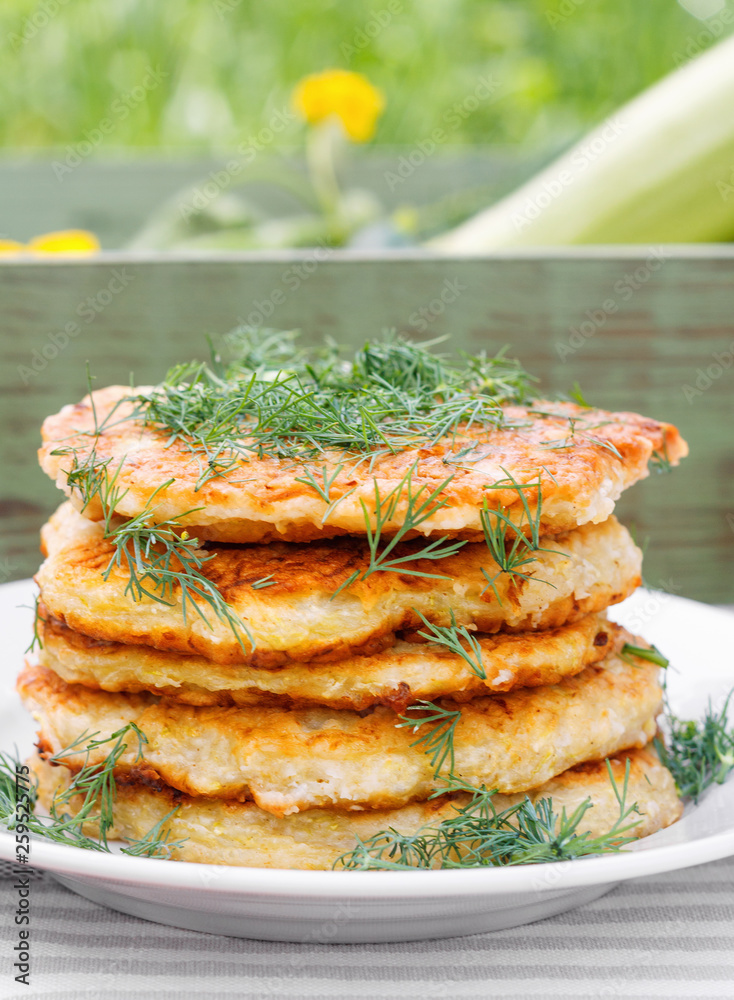 Delicious pancakes from courgettes and fresh vegetables with sour cream and dill Delicious pancakes from courgettes and fresh vegetables with sour cream and dill