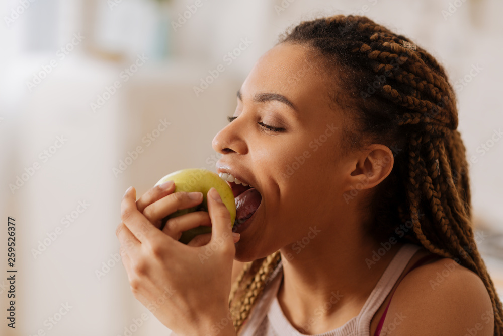 Beautiful young woman biting nice green apple in the morning Beautiful young woman biting nice green apple in the morning