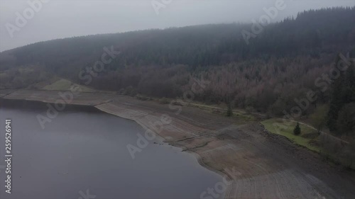 AERIAL DRONE footage of Ladybower Reservoir in the Peak District, UK, on a foggy and misty December day. photo