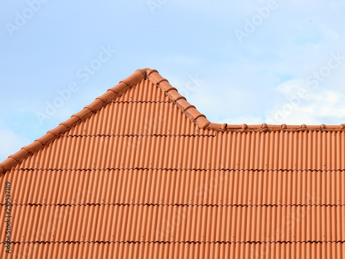 orange metal tile roof with blue sky