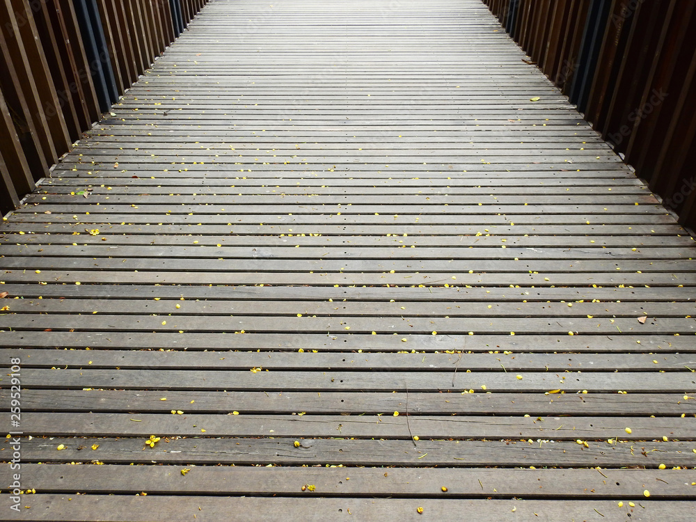 floor of wood bridge with yellow flower in park floor of wood bridge with yellow flower in park
