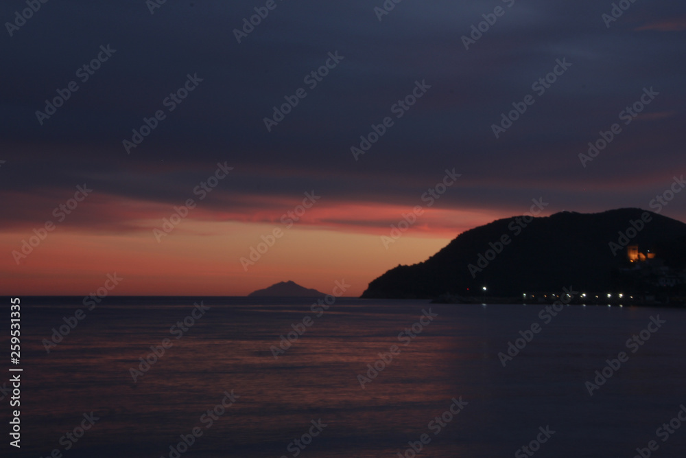 Sunset over Marina di Campo bay and Montecristo island, Elba island, Tuscany, Italy