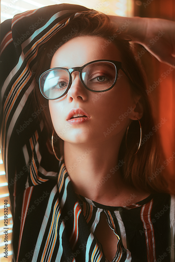 Beauty sexy fashion model woman portrait wearing glasses. Elegant woman  looking at camera in the black glasses, fashion beauty girl near window.  Modern blue tone. Portrait. Stock Photo | Adobe Stock