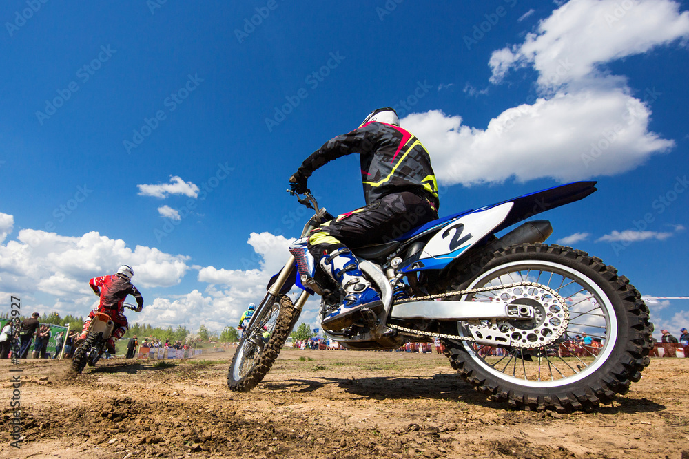 Motocross. racer on a motorcycle close-up on a dirty track Motocross. racer on a motorcycle close-up on a dirty track