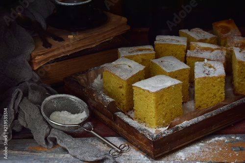 Homemade corn cake with tangerines on dark background. Traditional Brazilian sweet pie. Cornbread. Style Dark Moody.