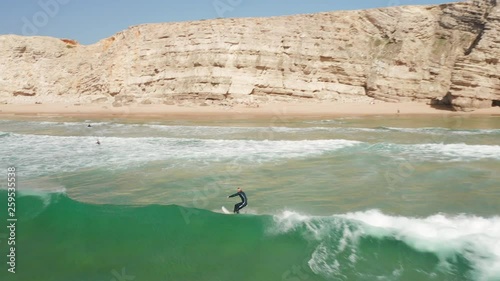 Aerial: Surfers at Sagres during a sunny day.