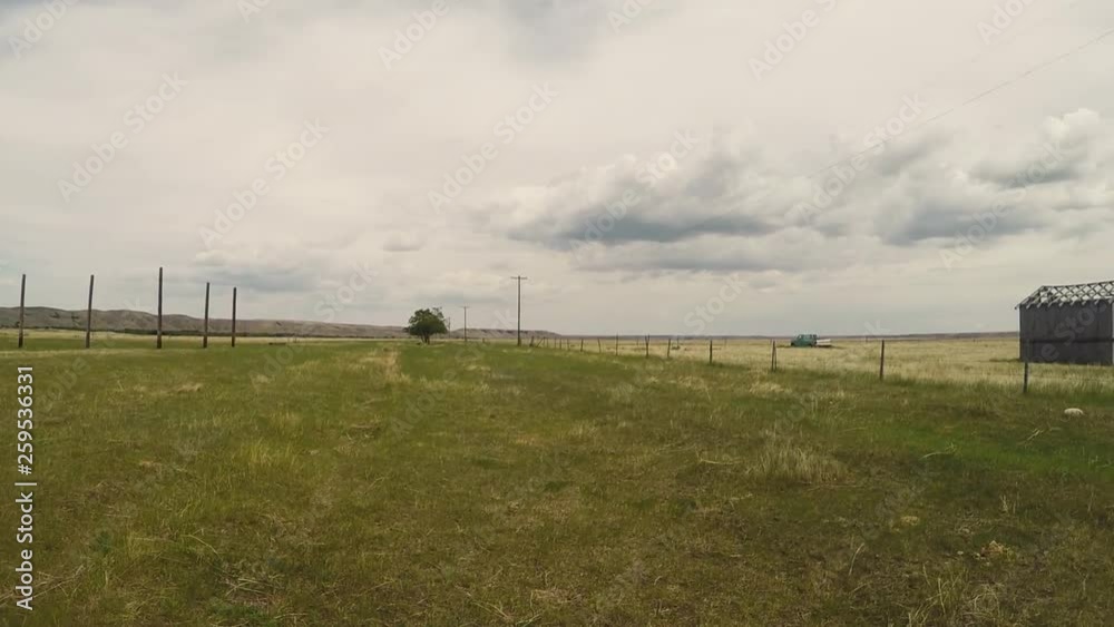 Field and a barn in country farm land on a grey cloudy day. Field and a barn in country farm land on a grey cloudy day.