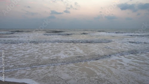 Wallpaper Mural Foamy waves rolling on tropical empty beach, pink clouds sunset background. Torontodigital.ca