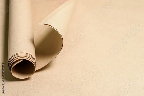 Kraft paper roll on kraft paper background. Eco paper. Recyclable, ecological. Place for text