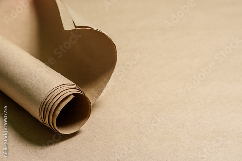 Kraft paper roll on kraft paper background. Eco paper. Recyclable, ecological. Place for text