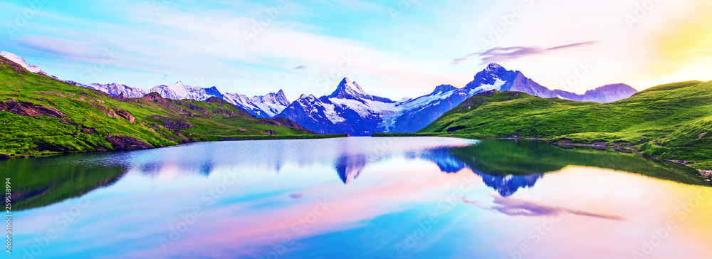 Fantastic landscape at sunrise over the lake in the Swiss Alps.