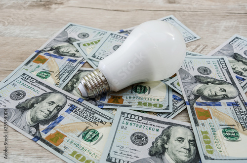 energy saving bulb on dollars