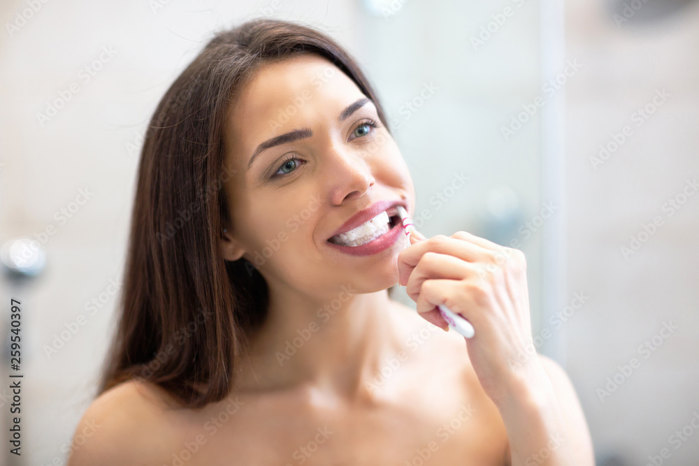 Very pretty girl with brown hair brushing her teeth Very pretty girl with brown hair brushing her teeth