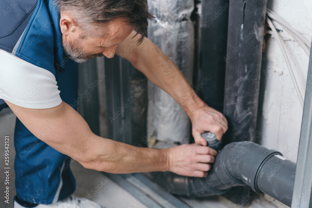 Handyman checking a plumbing connection