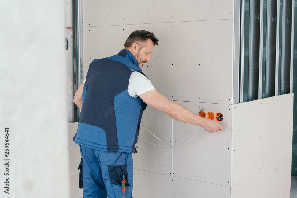 Handyman working on electric plug sockets