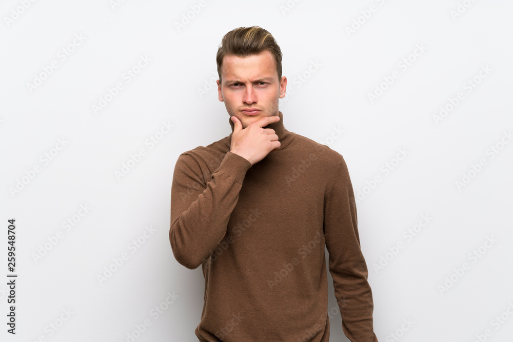 Blonde man over isolated white wall looking to the front Blonde man over isolated white wall looking to the front