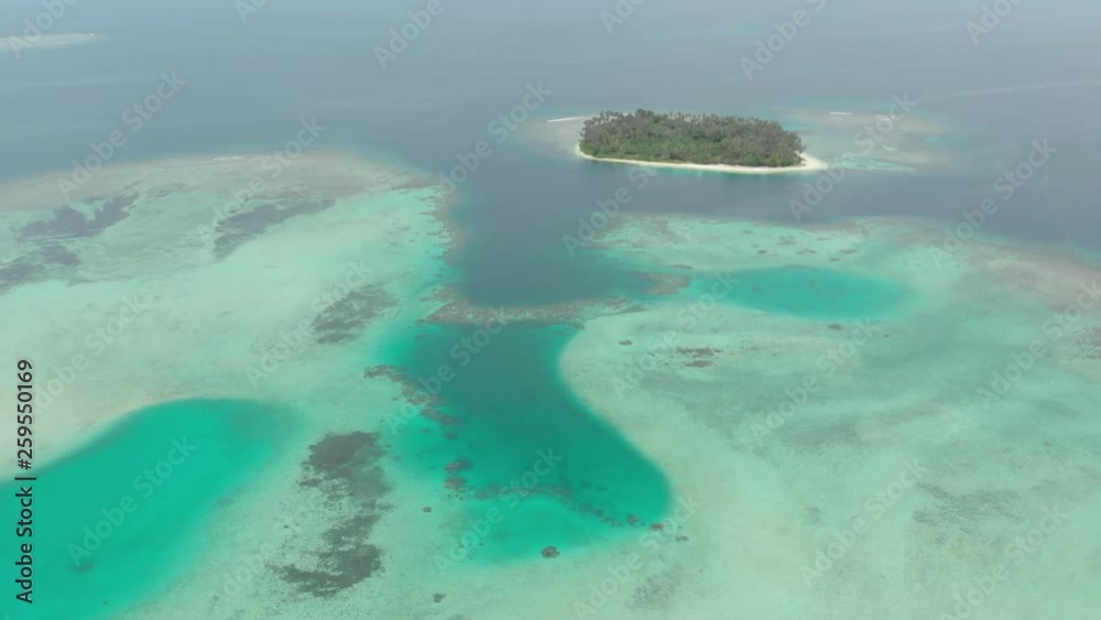 Aerial: flying over coral reef tropical islands caribbean sea turquoise blue water. Indonesia Sumatra Banyak islands. Travel destination diving snorkeling. Native cinelike D-log color profile