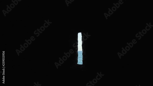 Tiny window in a prison cell on Goree Island, Senegal. Dark room. Dark atmosphere. photo