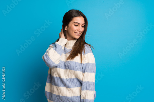 Young woman over blue wall