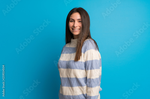 Young woman over blue wall