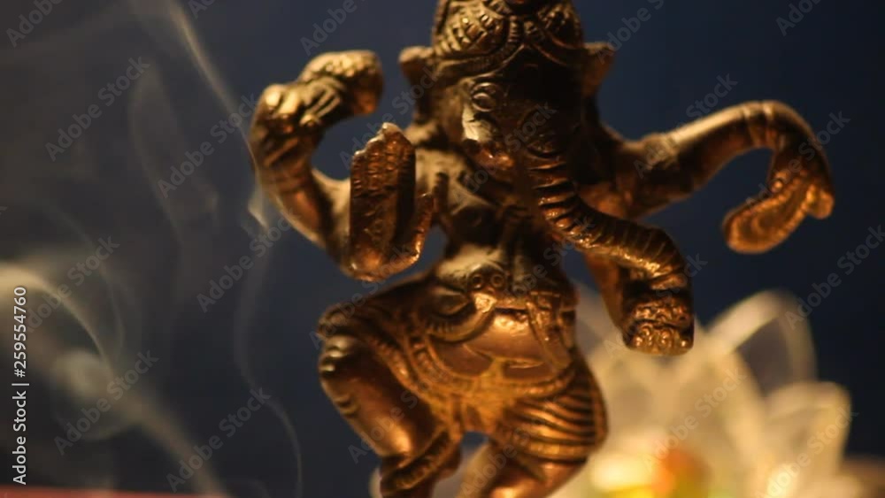 Ganesha statue with candle lights and incense smoke close up 11 Ganesha statue with candle lights and incense smoke close up 11