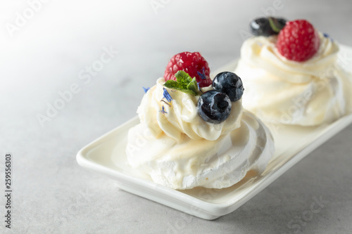 Dessert Pavlova with blueberries and raspberries.