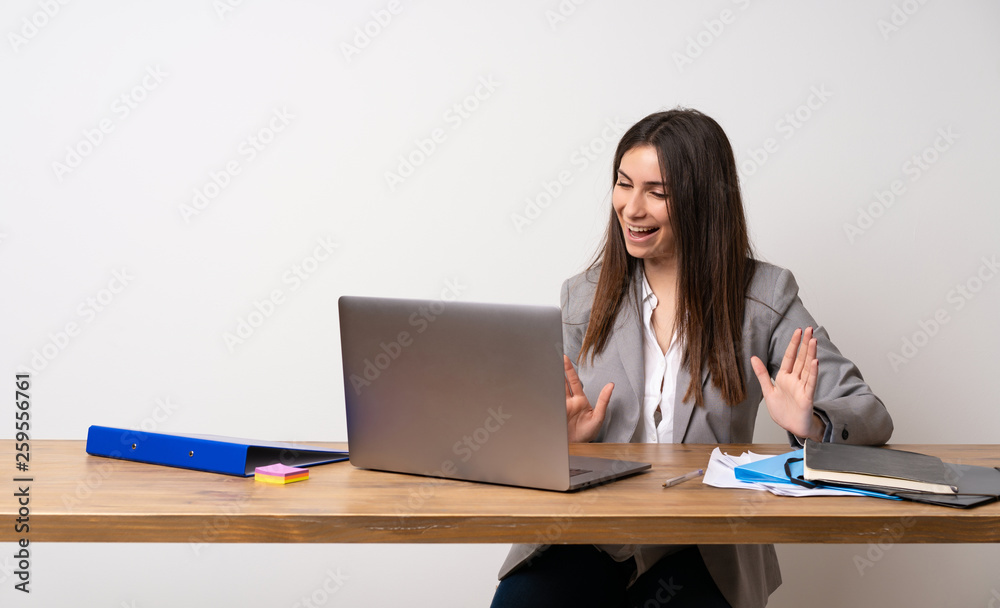 Business woman in a office smiling Business woman in a office smiling
