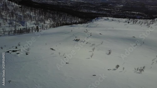 aerial drone flight over beautiful mountain chain with snow trees.epic panorama sightseeing,glory nature inspiration with cold rivers lies from a far.daylight in norway.shot in 4K 30fps photo