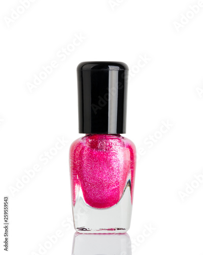 Bottle of red nail polish with glitter closeup.