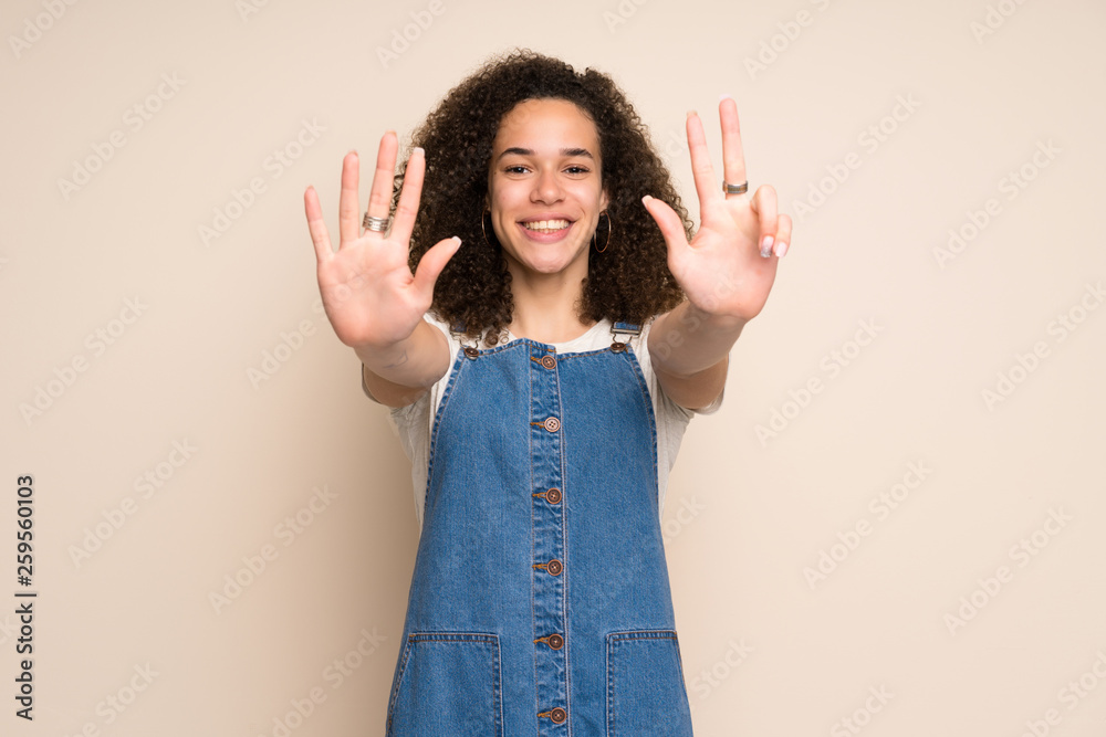 Dominican woman with overalls counting eight with fingers Dominican woman with overalls counting eight with fingers