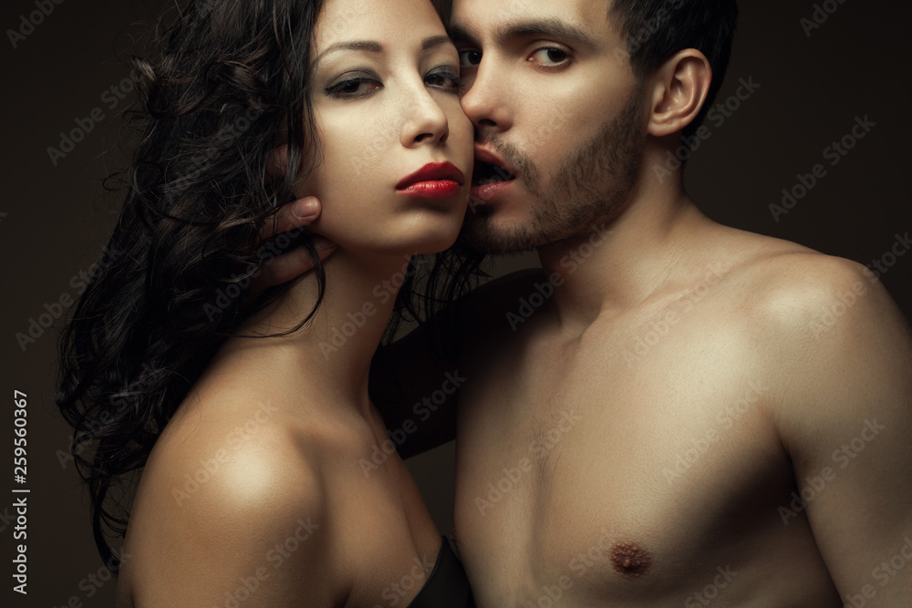 Emotive portrait of two lovers over chocolate background - handsome man and gorgeous woman with perfect hair and skin. Pure passion. Close up. Studio shot Emotive portrait of two lovers over chocolate background - handsome man and gorgeous woman with perfect hair and skin. Pure passion. Close up. Studio shot